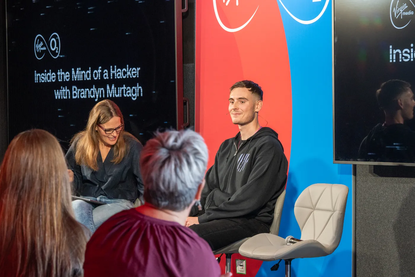 Brandyn being interviewed on stage at Virgin Media O2's Inside the Mind of a Hacker session